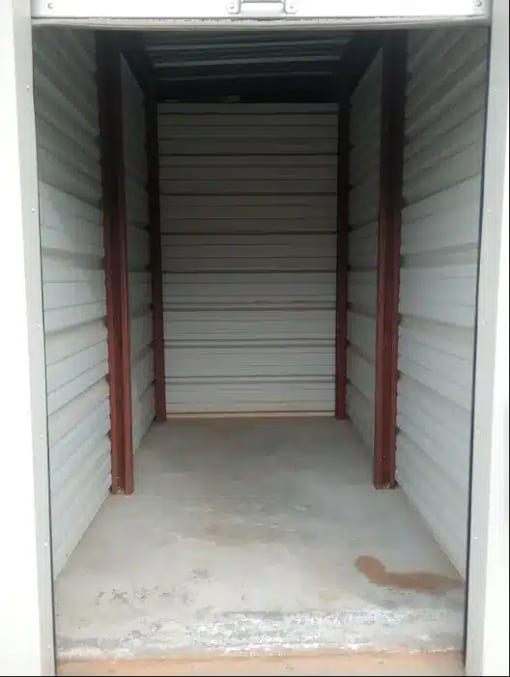 the inside of a small closet with white flooring and white walls
