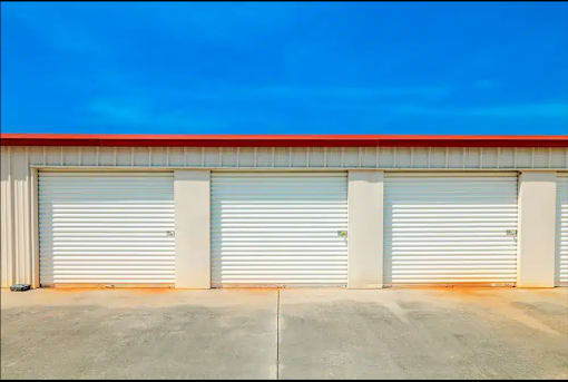the side of a building with three garage doors
