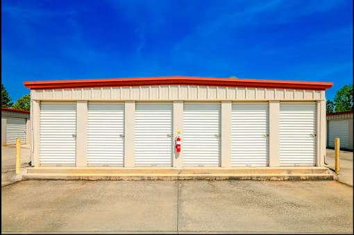 a small building with a fire hydrant in front of it