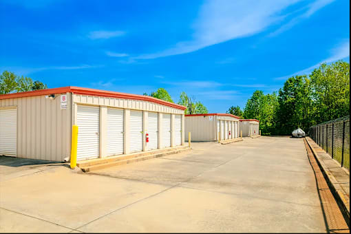a row of garages and sheds in a parking lot