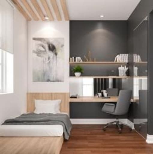 A bedroom with a bed, desk, and chair.