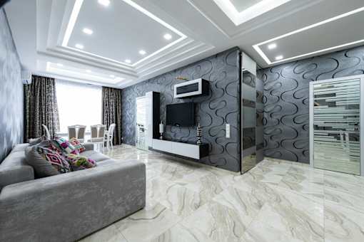 A modern living room with a grey sofa and a television.