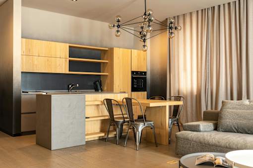 A modern kitchen with a dining table and chairs.