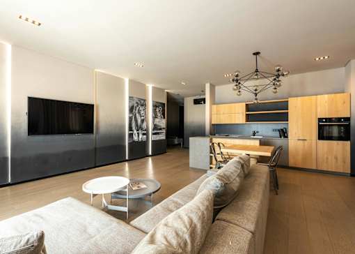 A modern living room with a long couch and a coffee table.