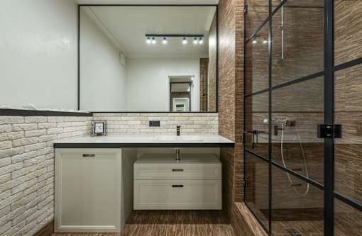 A bathroom with a white countertop and a white sink.
