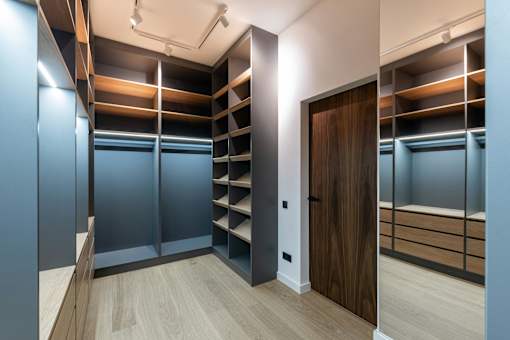 A room with a wooden floor and a brown door.