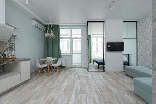 A modern living room with a dining table and chairs.