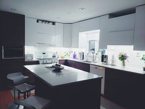 A modern kitchen with a large island and a dining area.