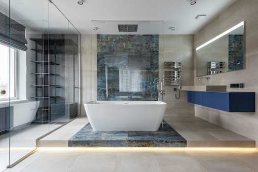 A modern bathroom with a large tub and a glass shower.