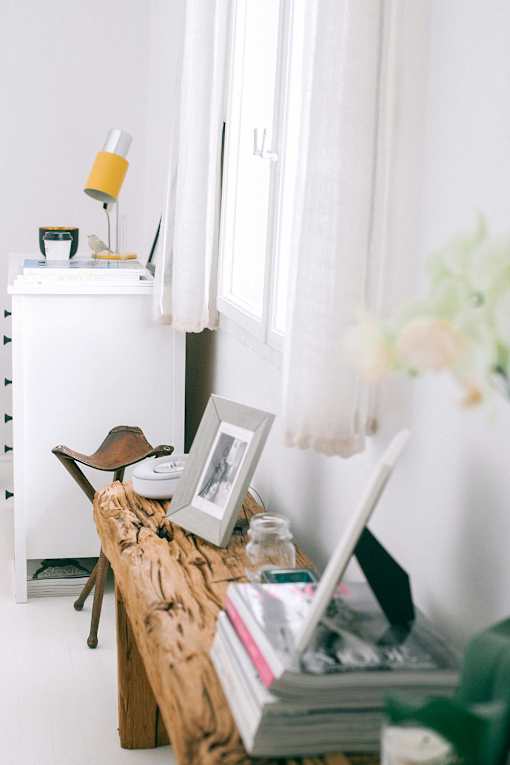 A white dresser with a lamp and a picture frame on top of it.