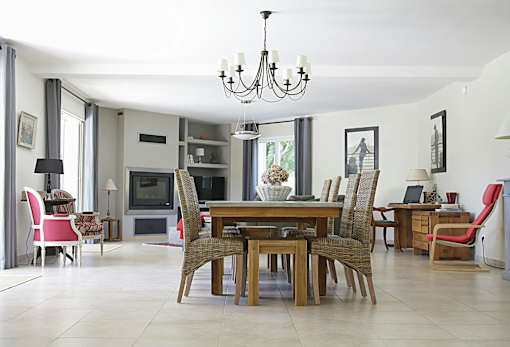 A dining room with a wooden table and chairs.