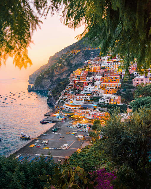 A beautiful coastal town with colorful buildings and boats in the water.