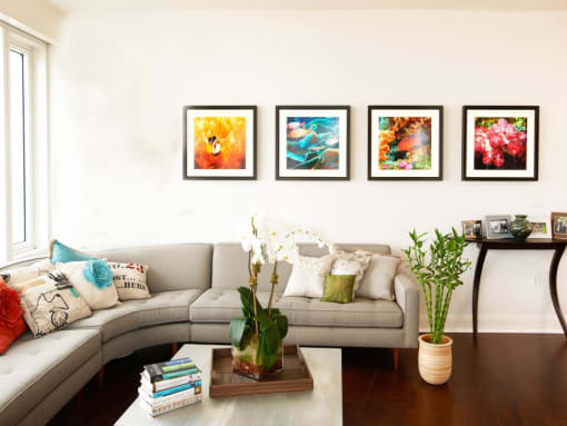 a living room with a couch and pictures on the wall