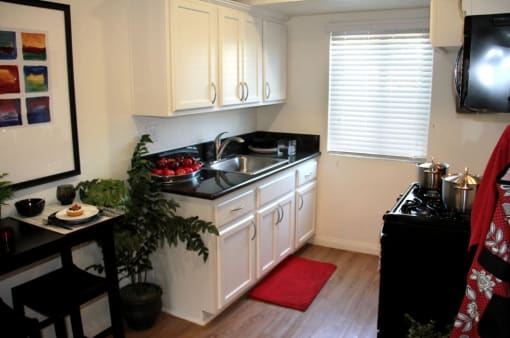 a kitchen with white cabinets and a sink