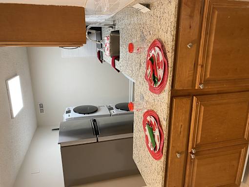 A kitchen with a stove top oven and a wooden door.