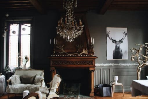 a living room with a fireplace and a chandelier