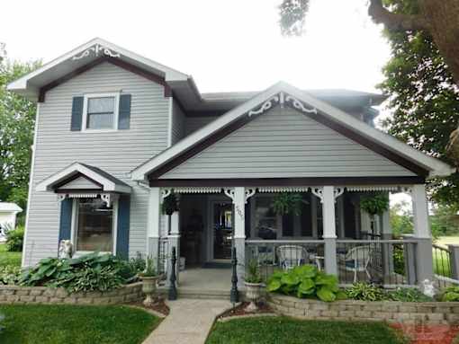 a blue house with a porch and a patio