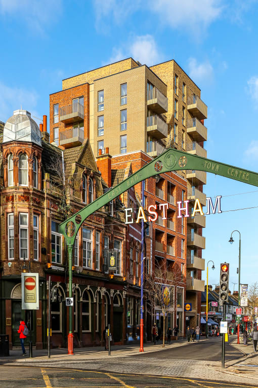 a large building on a city street with a sign that reads east ham