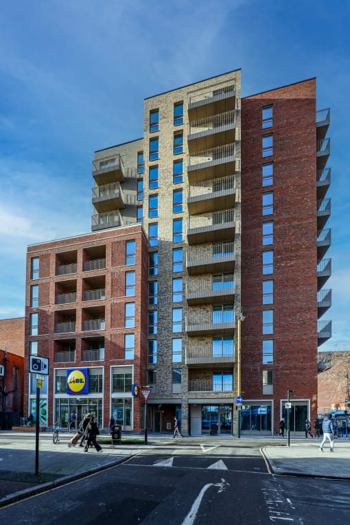 a rendering of a large brick building on a city street