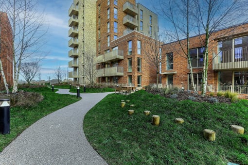 a walking path in front of an apartment building
