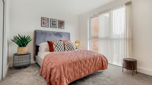a bedroom with a bed and a large window