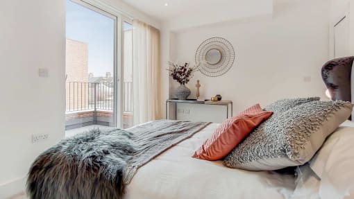 a bedroom with a bed and a large window