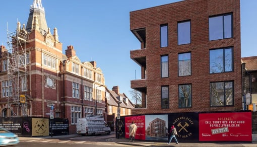 a city street with brick buildings and a building with scaffolding