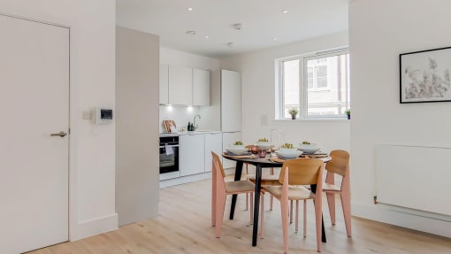 a kitchen and dining area with a table and chairs