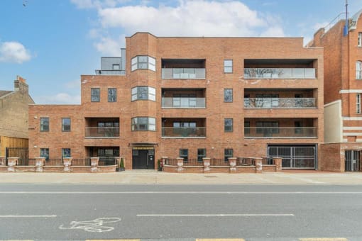 a large brick building on the side of a street