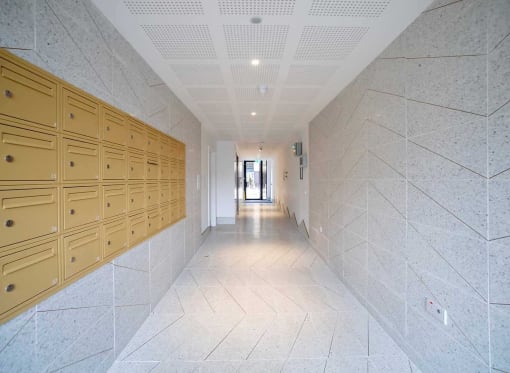 a long hallway with rows of lockers in a building