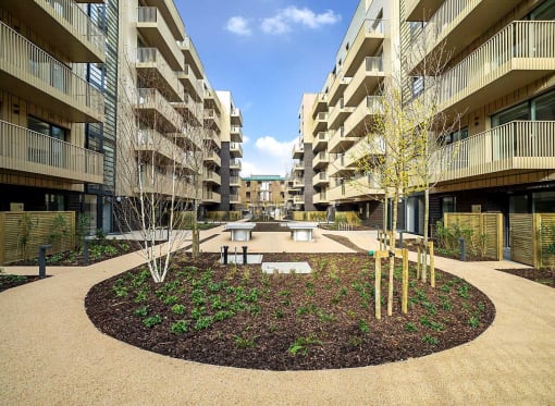 a courtyard with a fountain in the middle of an apartment building