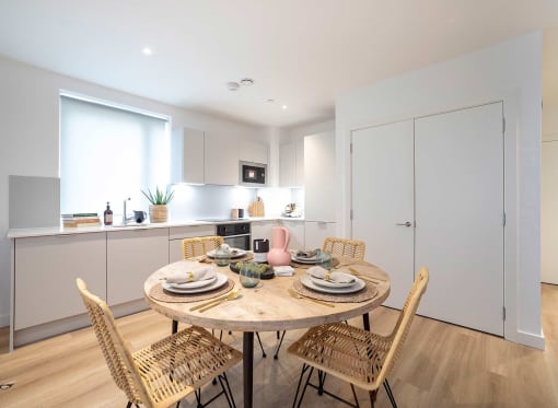a kitchen and dining area with a table and chairs