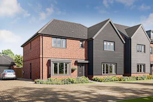 A modern house with a grey roof and a brick chimney.