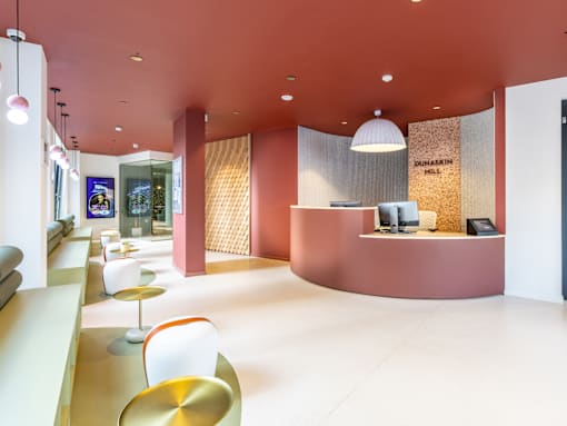 A reception area with a white counter and a sign that says "Dohasin Hill.".