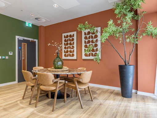 A dining room with a table set for six.