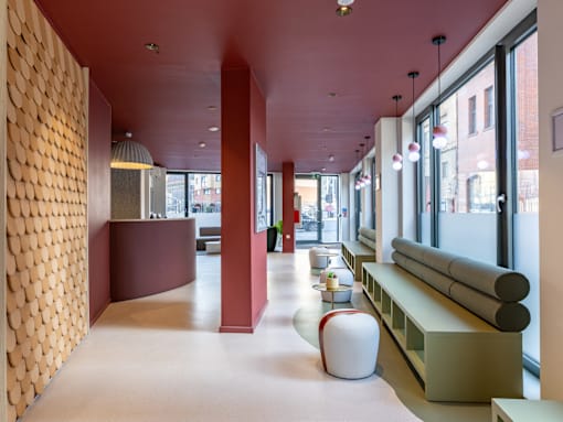 A long hallway with a red ceiling and a white floor.