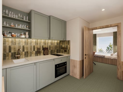A kitchen with grey cabinets and a tiled backsplash.