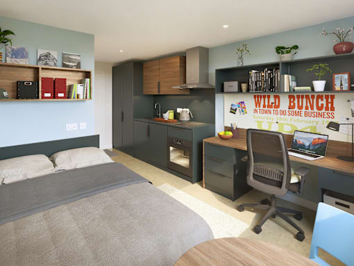 A bedroom with a bed, desk, and a poster on the wall.