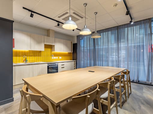 A conference room with a long table and chairs.