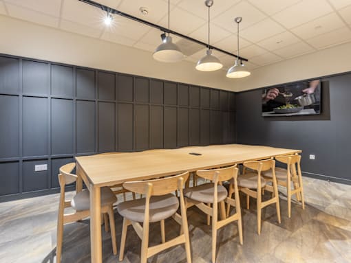 A conference room with a long table and chairs.