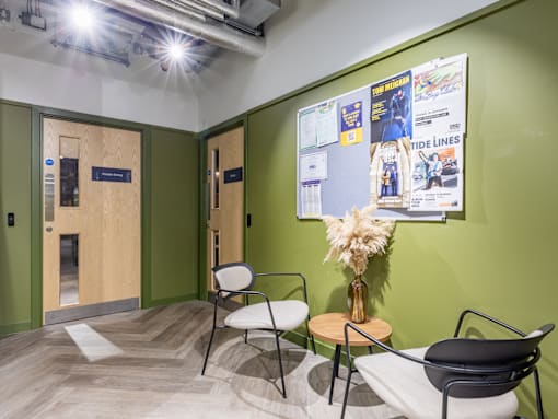 A room with a green wall and a poster on it.