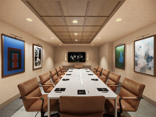A conference room with a long table and chairs.