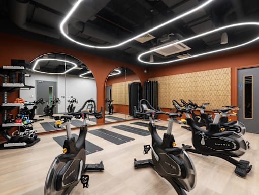 A gym with stationary bikes and a variety of exercise equipment.