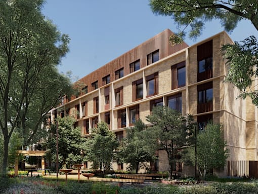 A modern building with a lot of windows and trees in front.