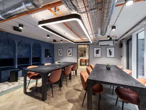 A conference room with a long table and chairs.
