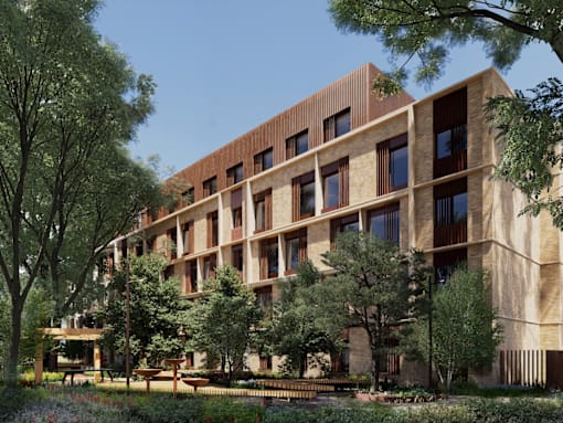 A modern building with a lot of windows and trees in front.