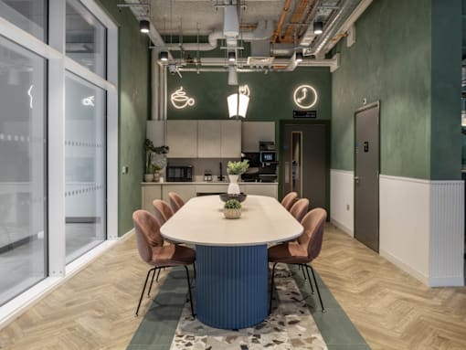 A modern dining area with a round table and chairs.