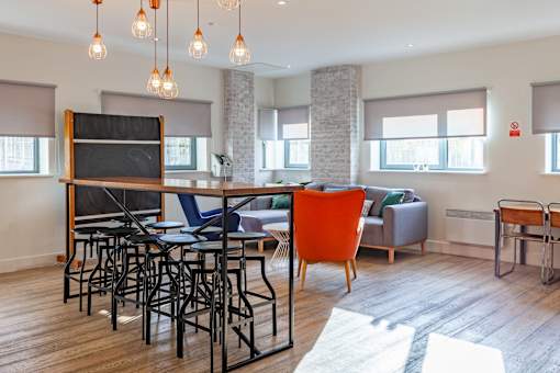 A modern living room with a bar area and a television.