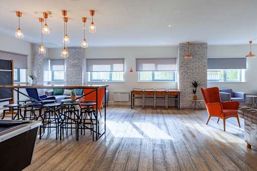 A modern living room with a wooden floor and a stone pillar.