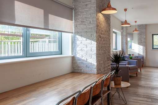 A room with a brick wall and wooden floors.